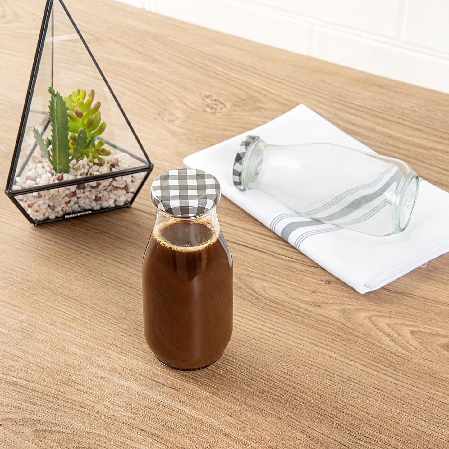 Restaurantware French Countryside 11 Ounce Glass Bottles 10 Durable Juice Bottles - With Black Plaid Lid Dishwashable Clear Glass Countryside Bottles For Hot And Cold Beverages